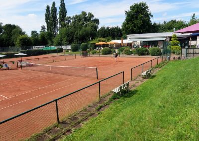 Foto eines Tennisspielers der Farmsen Open beim Aufschlag aus der Ferne